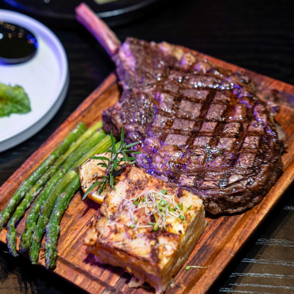 Close-up of a premium Tomahawk steak served at the Charlotte Steak & Wine Experience
